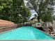 Backyard view of an above ground pool with deck and fenced yard at 204 Aspen Dr, Gastonia, NC 28052