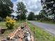 Residential street with neighboring homes; some road construction elements are visible at 204 Aspen Dr, Gastonia, NC 28052