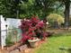 Backyard with a mature garden, a shed, a white fence and wooden border at 204 Aspen Dr, Gastonia, NC 28052