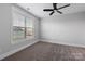 Bedroom features large window, neutral walls, carpet and ceiling fan at 2075 Fordhill St, Rock Hill, SC 29732