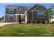 Charming two-story home with stone accents, grey siding, manicured lawn, and well-maintained landscaping at 2075 Fordhill St, Rock Hill, SC 29732