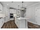 Well-equipped kitchen with an island, stainless steel appliances, white cabinetry, and modern pendant lighting at 2075 Fordhill St, Rock Hill, SC 29732