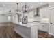 Modern kitchen with stainless steel appliances, white cabinets, island, and stylish lighting at 2075 Fordhill St, Rock Hill, SC 29732