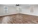 Open and bright living room featuring stylish wood flooring, a modern ceiling fan, and three large windows at 2075 Fordhill St, Rock Hill, SC 29732