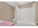 Bright bathroom featuring a shower-tub combination, toilet, and sink with a pink countertop at 212 Pointe Cir, Rock Hill, SC 29732
