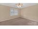 Bedroom with neutral carpet, natural light from the shuttered windows, and ceiling trim at 212 Pointe Cir, Rock Hill, SC 29732