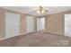 Bedroom showcasing neutral walls, carpet, ceiling fan, and doors leading to other rooms in home at 212 Pointe Cir, Rock Hill, SC 29732