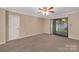 Neutral bedroom with carpet flooring, ceiling fan, and sliding doors to the backyard at 212 Pointe Cir, Rock Hill, SC 29732