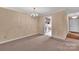 Neutral dining room with carpet flooring, stylish chandelier, and view of the kitchen at 212 Pointe Cir, Rock Hill, SC 29732