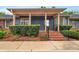 Inviting blue home featuring a brick-lined front entrance, stylish columns, and manicured landscaping at 212 Pointe Cir, Rock Hill, SC 29732