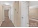 Hallway featuring neutral walls, carpet flooring, and multiple white doors adding functionality to the home at 212 Pointe Cir, Rock Hill, SC 29732