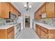 Functional kitchen with white appliances, tiled backsplash, and ample wooden cabinetry at 212 Pointe Cir, Rock Hill, SC 29732