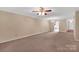 Cozy living room with carpet flooring, ceiling fan, and access to other rooms at 212 Pointe Cir, Rock Hill, SC 29732