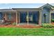 A covered outdoor patio providing shade and view to grassy backyard and mature landscaping at 212 Pointe Cir, Rock Hill, SC 29732