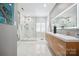 Modern bathroom showcasing a glass-enclosed shower, double vanity, and marble tile flooring at 21203 Harken Dr, Cornelius, NC 28031