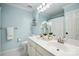 Well-lit bathroom featuring double sinks, modern fixtures, and a clean, fresh aesthetic at 21203 Harken Dr, Cornelius, NC 28031