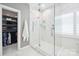 Updated bathroom featuring a marble tiled walk-in shower, glass door, and linen closet at 21203 Harken Dr, Cornelius, NC 28031