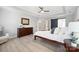Light filled primary bedroom with ceiling fan, ensuite bath access, and contemporary decor at 21203 Harken Dr, Cornelius, NC 28031