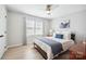 Cozy bedroom with light hardwood floors, large windows, and a comfortable queen-size bed at 21203 Harken Dr, Cornelius, NC 28031