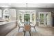 Bright dining room with large windows, modern chandelier, and access to the backyard patio at 21203 Harken Dr, Cornelius, NC 28031