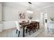 Elegant dining room with chandelier, decorative wainscoting, and a sophisticated ambiance at 21203 Harken Dr, Cornelius, NC 28031
