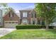 Charming two-story brick home with well-manicured lawn and a two-car garage at 21203 Harken Dr, Cornelius, NC 28031