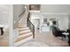 Bright and inviting foyer featuring hardwood floors and an elegant staircase with metal railings at 21203 Harken Dr, Cornelius, NC 28031
