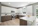 Modern kitchen featuring sleek white cabinets, stainless steel appliances, and quartz countertops at 21203 Harken Dr, Cornelius, NC 28031