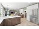 Open concept kitchen with stainless steel appliances, white cabinets, and seamless access to the living area at 21203 Harken Dr, Cornelius, NC 28031