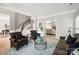 Elegant living room with leather chairs, a brown couch, and views into other rooms at 21203 Harken Dr, Cornelius, NC 28031