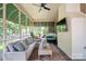 Screened-in porch features comfortable seating, a ceiling fan, and a view of the beautiful backyard at 21203 Harken Dr, Cornelius, NC 28031