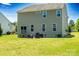 The rear exterior of a home features a well-kept lawn and a small patio area, great for outdoor relaxation at 217 Hydrangea Dr, Clover, SC 29710