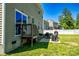A backyard with a small deck and patio area, perfect for barbecuing and relaxing, next to lush green grass at 217 Hydrangea Dr, Clover, SC 29710