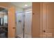 Bathroom featuring glass shower, neutral paint, and access to another room at 217 Hydrangea Dr, Clover, SC 29710