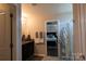Bathroom featuring dark vanity, granite countertop, and access to main bedroom at 217 Hydrangea Dr, Clover, SC 29710