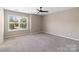 Bedroom featuring carpet, ceiling fan, and natural light from the large window at 217 Hydrangea Dr, Clover, SC 29710