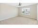 Bright bedroom with neutral carpet, ceiling fan, and a large window at 217 Hydrangea Dr, Clover, SC 29710
