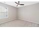 Bedroom featuring carpet, ceiling fan, and natural light from the large window at 217 Hydrangea Dr, Clover, SC 29710