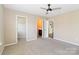 Spacious bedroom with neutral carpet, ceiling fan and entry to the bathroom and walk-in closet at 217 Hydrangea Dr, Clover, SC 29710