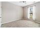 Bright bedroom with neutral walls, carpet flooring, ceiling fan, and a window dressed with white curtains at 217 Hydrangea Dr, Clover, SC 29710