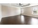 Main bedroom with a tray ceiling, two windows, and hardwood flooring at 217 Hydrangea Dr, Clover, SC 29710