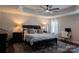 Large primary bedroom featuring tray ceiling, ceiling fan, and two windows at 217 Hydrangea Dr, Clover, SC 29710