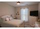 Cozy bedroom with a ceiling fan, window with blinds, and a comfortable bed with plush pillows at 217 Hydrangea Dr, Clover, SC 29710