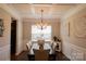 Formal dining room featuring wainscotting, a coffered ceiling, a chandelier and modern decor at 217 Hydrangea Dr, Clover, SC 29710