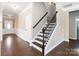 Elegant entryway with staircase, hardwood floors, and paneled walls at 217 Hydrangea Dr, Clover, SC 29710