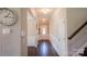 Welcoming foyer featuring hardwood floors, wainscoting, and a view of the front door and staircase at 217 Hydrangea Dr, Clover, SC 29710