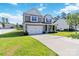 Charming two-story home with a well-maintained lawn and a two-car garage at 217 Hydrangea Dr, Clover, SC 29710