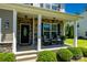 Charming covered front porch with stone accents, rocking chairs, and stylish decor, creating a welcoming entrance at 217 Hydrangea Dr, Clover, SC 29710