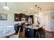 Modern kitchen with a large island, stainless steel appliances, pendant lighting, and dark cabinetry at 217 Hydrangea Dr, Clover, SC 29710