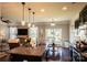 Open-concept kitchen with an island, stainless steel appliances, and dark cabinets overlooking the living area at 217 Hydrangea Dr, Clover, SC 29710